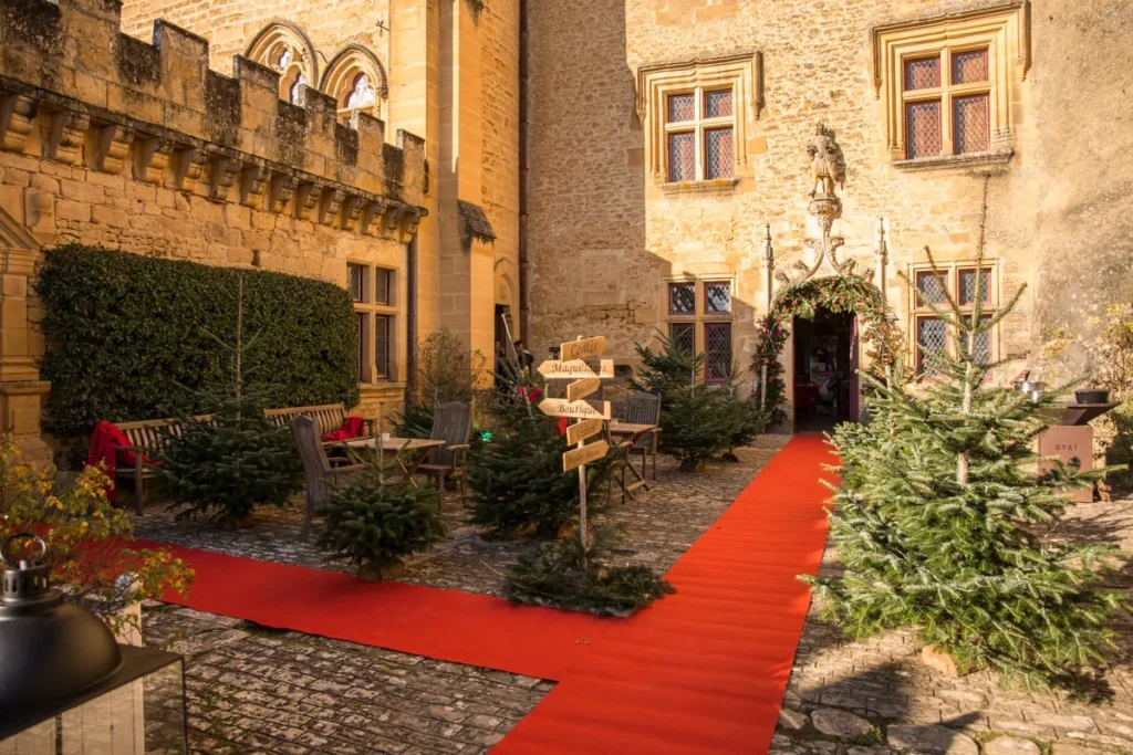 Château de Puymartin inner courtyard set up for Noël Gourmand, highlighting Christmas activities in Dordogne.