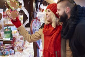 A couple happily buying gifts in the Christmas Markets in Dordogne.