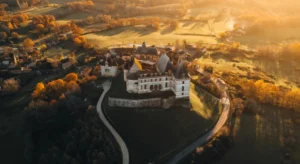 Aerial view of Dordogne Périgord in autumn with orange-hued trees surrounding the landscape.